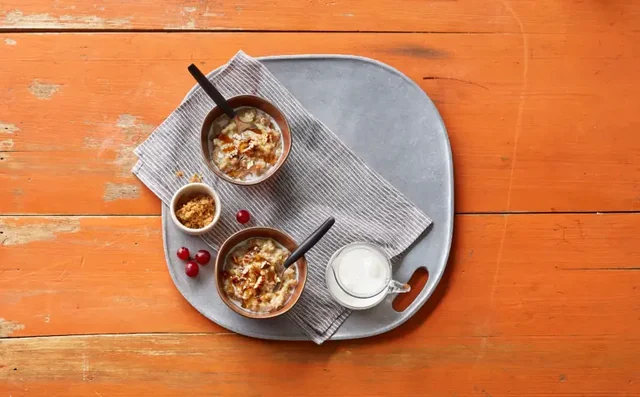Two bowls of maple and brown sugar oatmeal on a breakfast tray